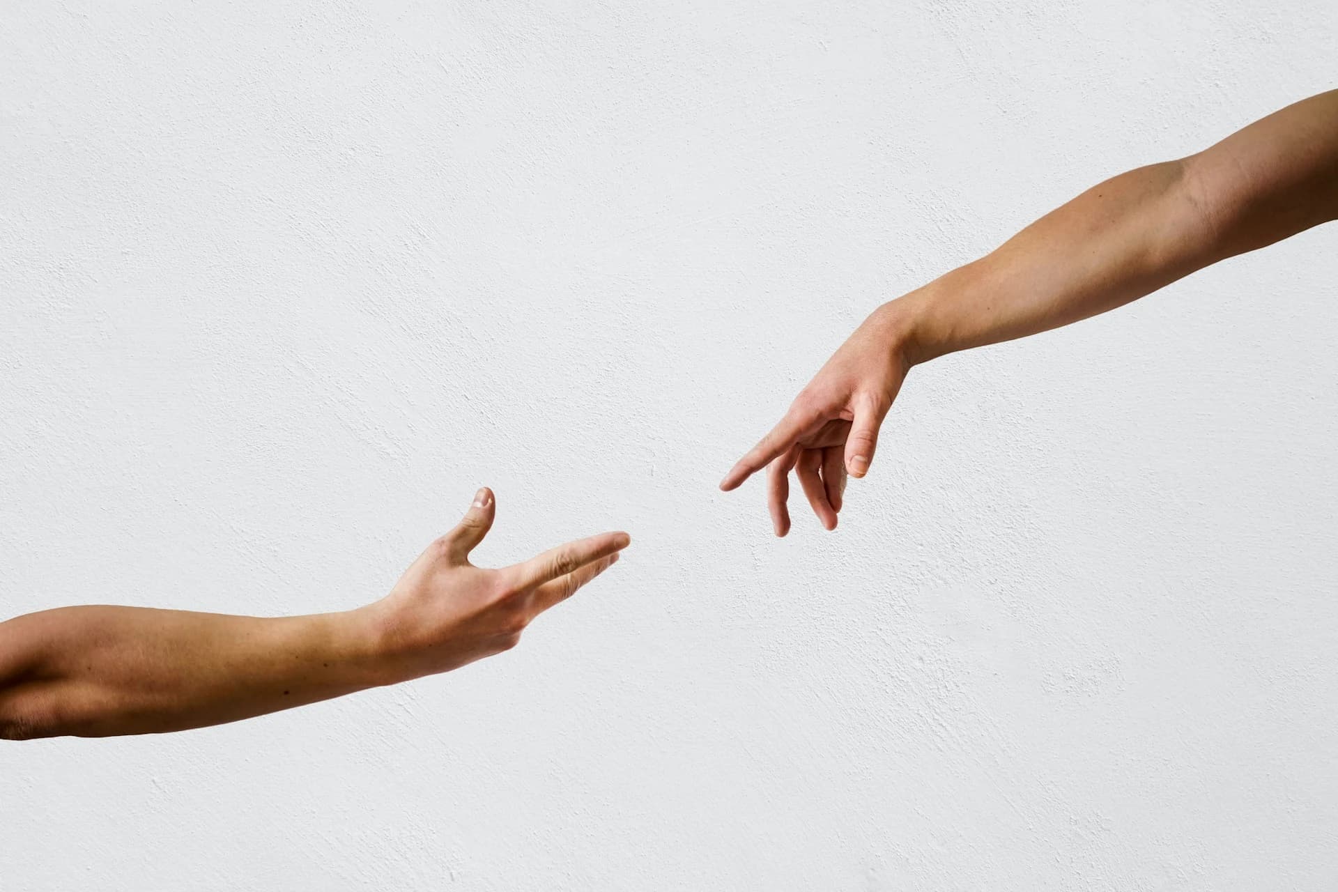 Two hands reaching for each other